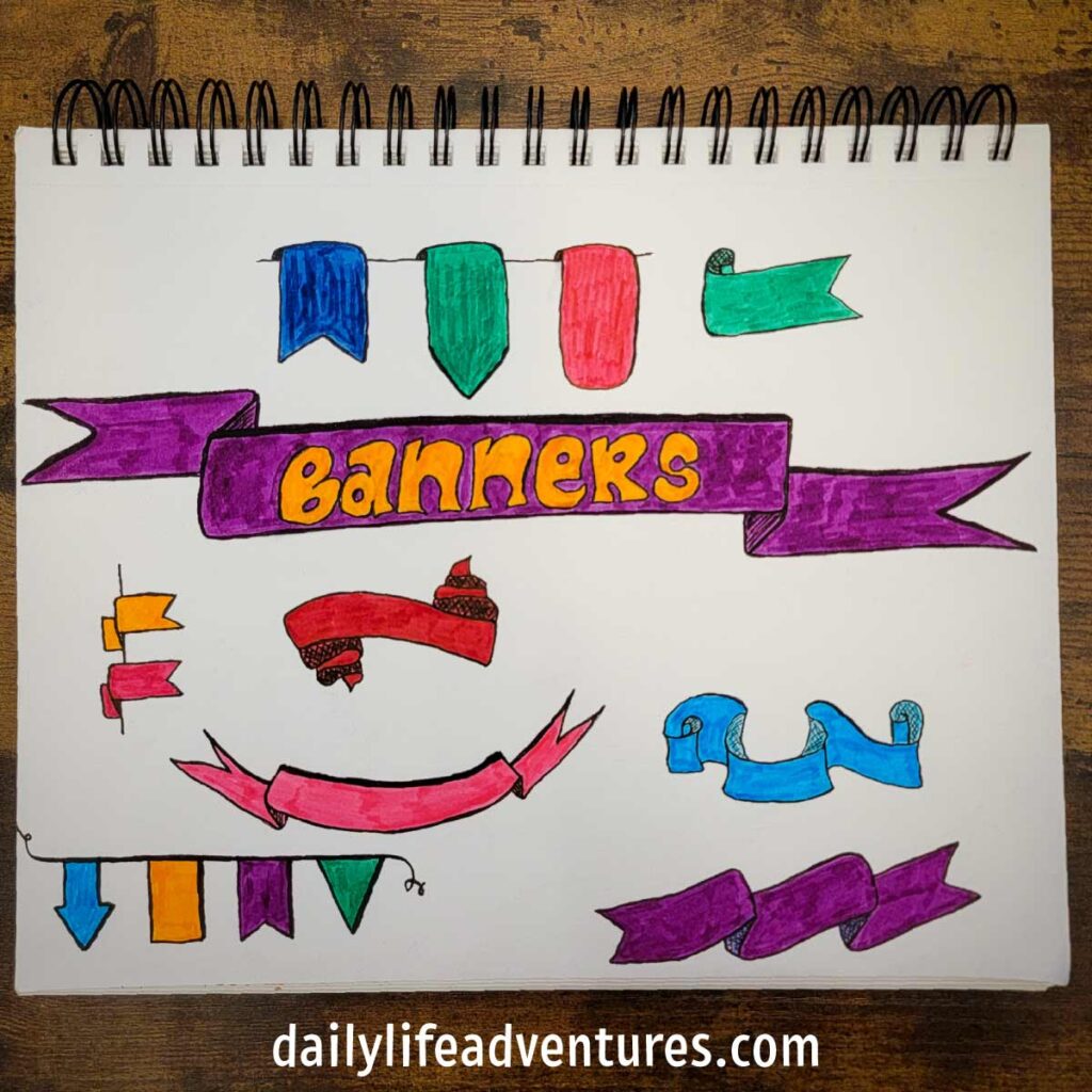 9 different bullet journal banners hand drawn on a sketchpad and colored in with markers.