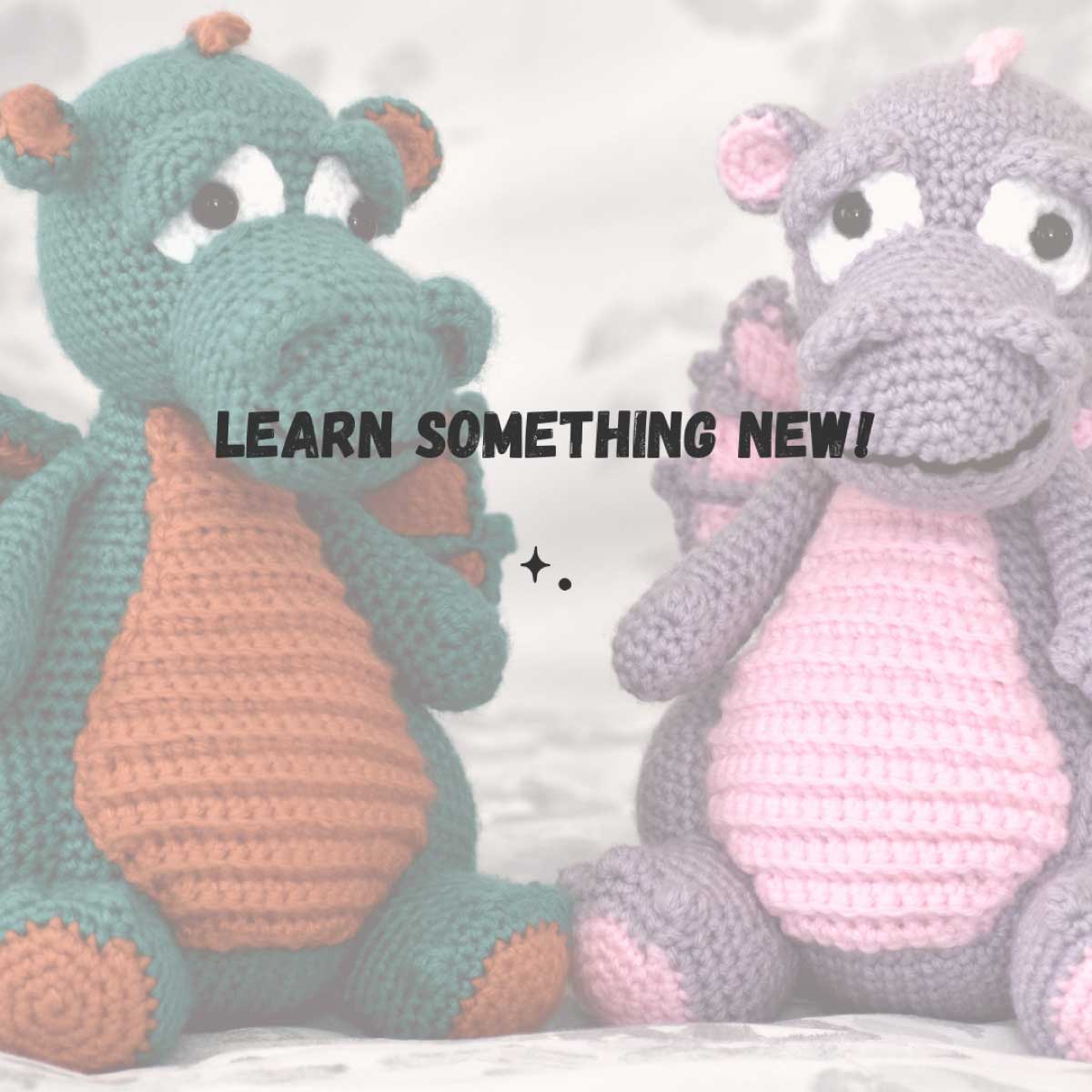 Learn something new! 2 crochet dragons on a bed to show a hobby.