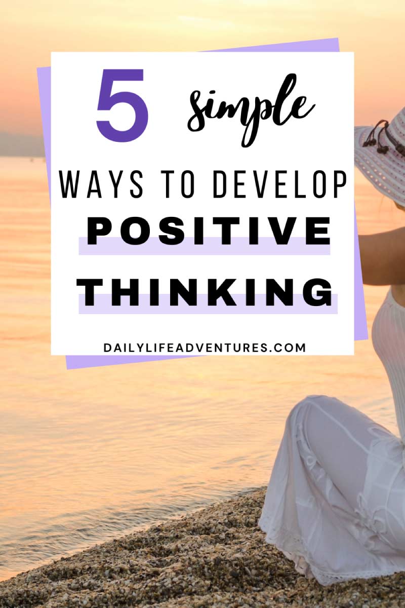 5 simple ways to develop positive thinking Pinterest image. A woman sitting on the ground in front of a big body of water over looking the water.