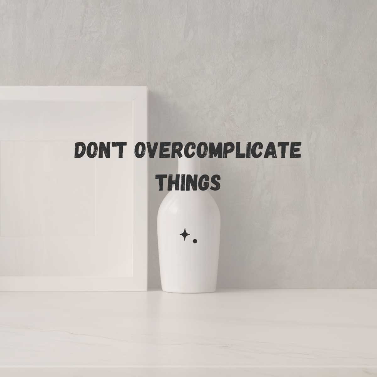 don't overcomplicate things. A white vase and white picture frame on a table by themselves to show simplicity.